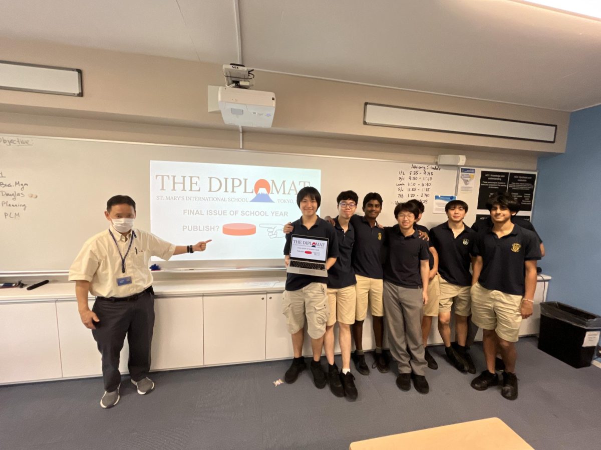 Mr. Kagei helps the students publish the last edition of the school year