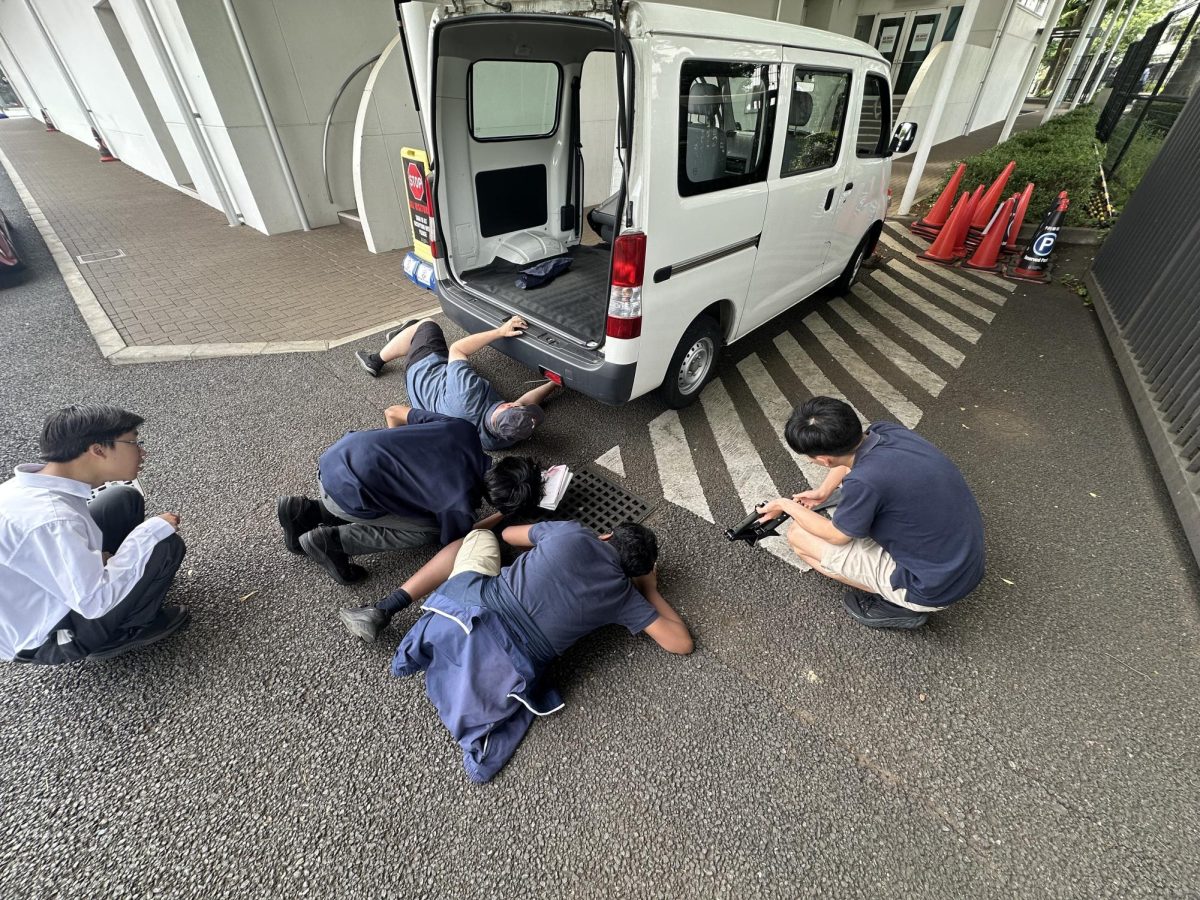 Mr. Kratz getting his hands dirty to demonstrate auto maintenance 