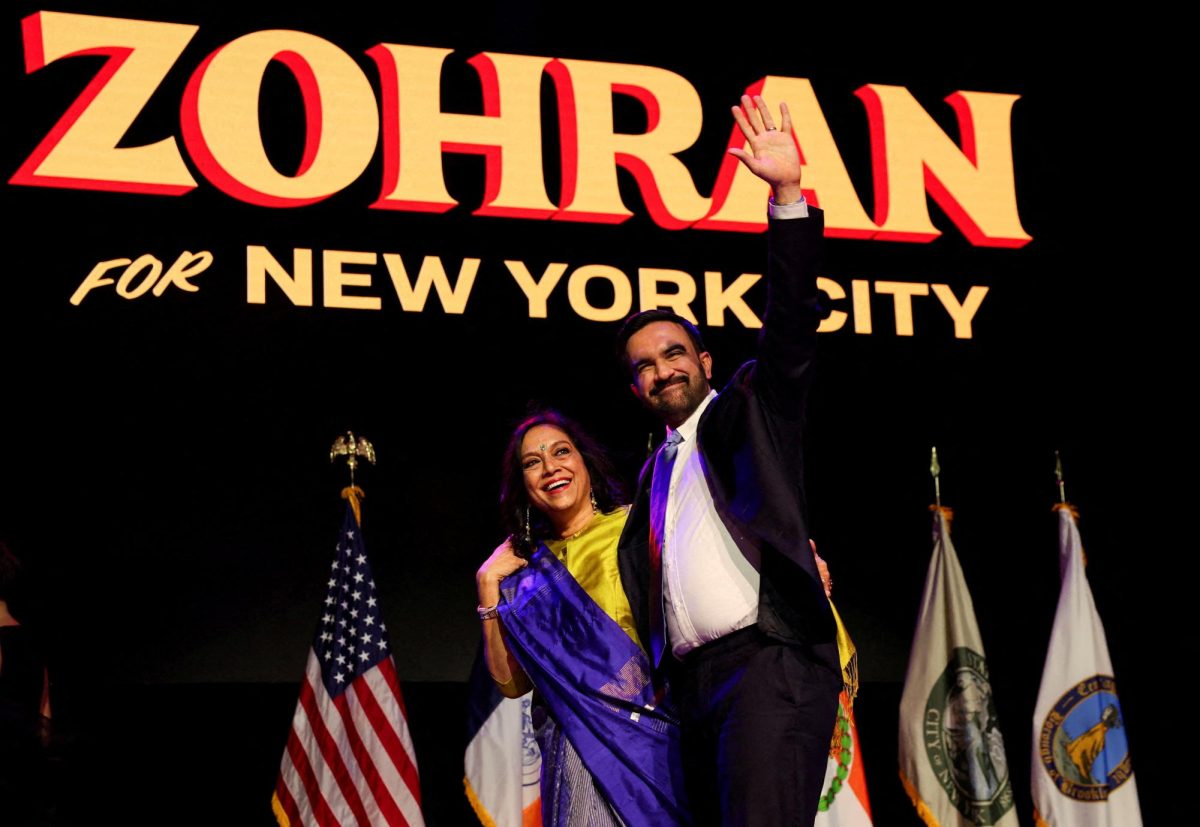 Democratic candidate for New York City mayor Zohran Mamdani waves next to his mother Mira Nair onstage after winning the 2025 New York City Mayoral race, at an election night rally in the Brooklyn borough of New York City, New York, U.S., November 4, 2025.  REUTERS/Shannon Stapleton