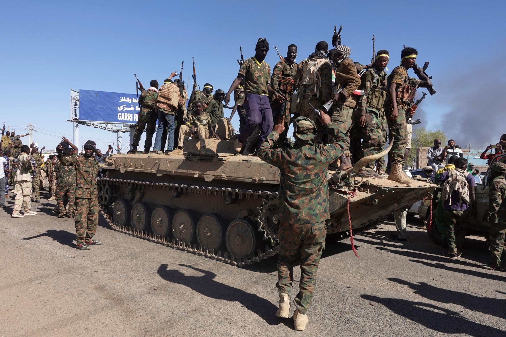 Sudan's army soldiers celebrate the army's liberation of an oil refinery, in North Bahri, Sudan, January 25, 2025. REUTERS/El Tayeb Siddig