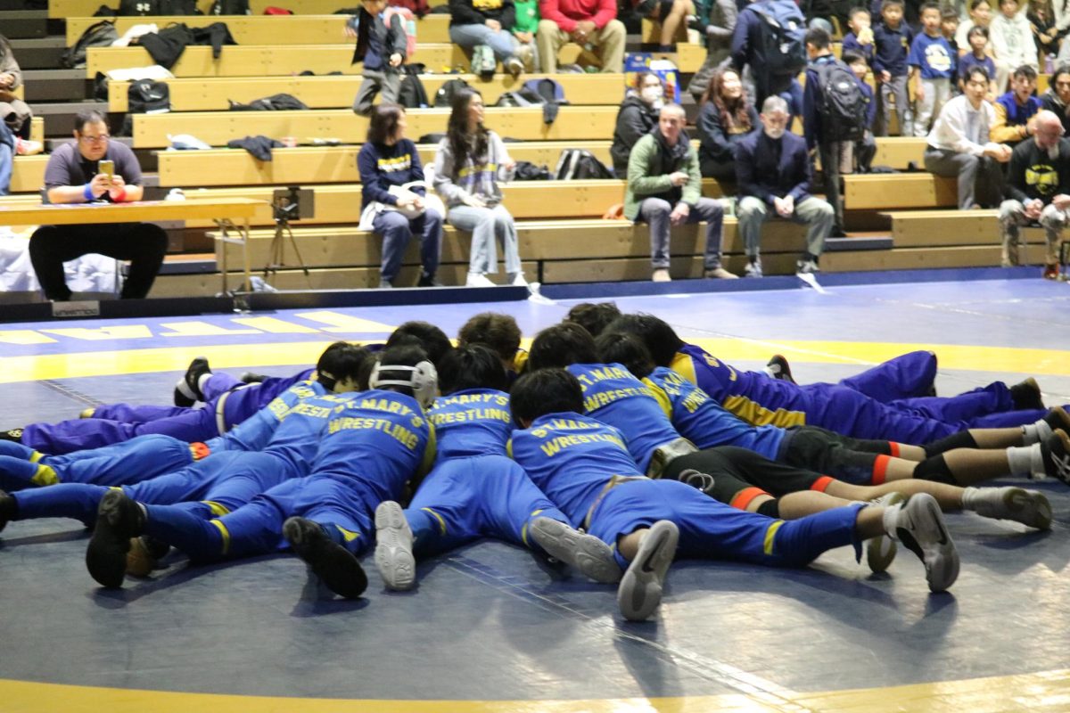 Wrestling team tradition of huddling before the game