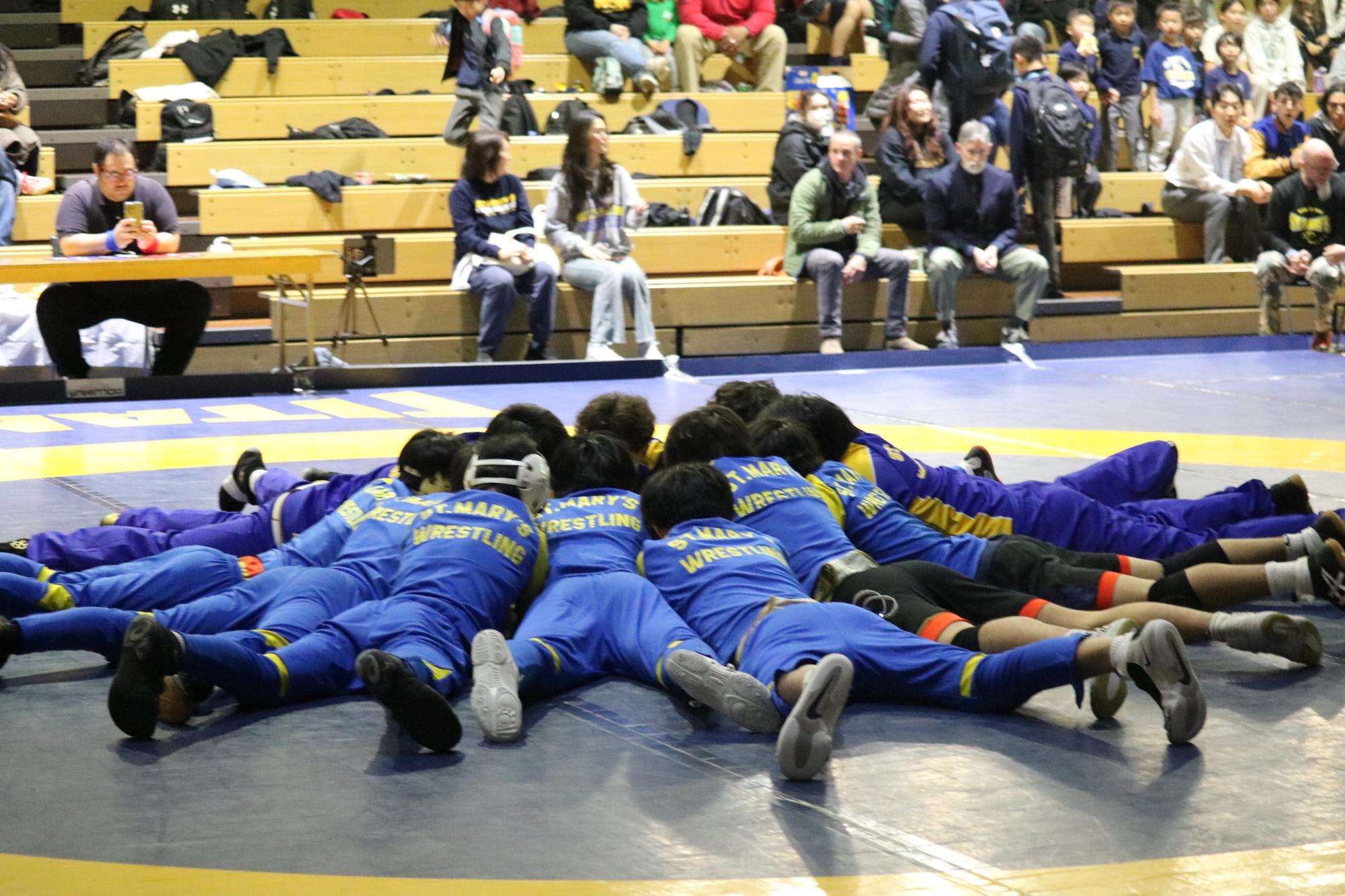 Wrestling team tradition of huddling before the game