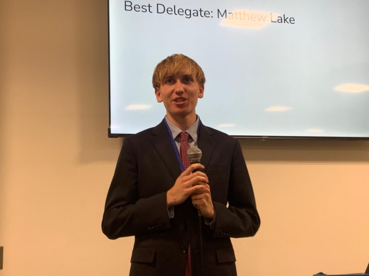 Kai Smith ('26) announcing the winners for the conference