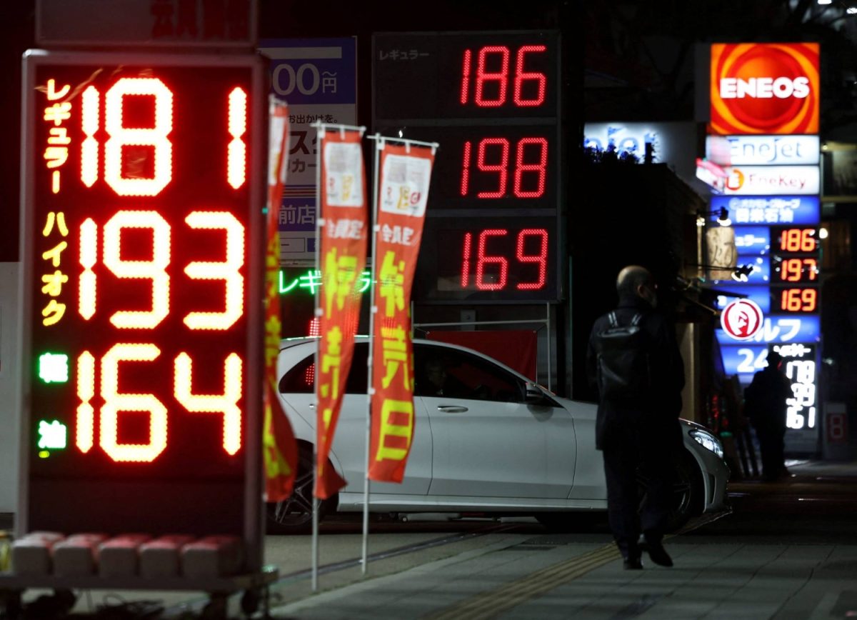 Signboards display fuel prices outside gas stations in Tokyo, Japan March 13, 2026. REUTERS/Issei Kato