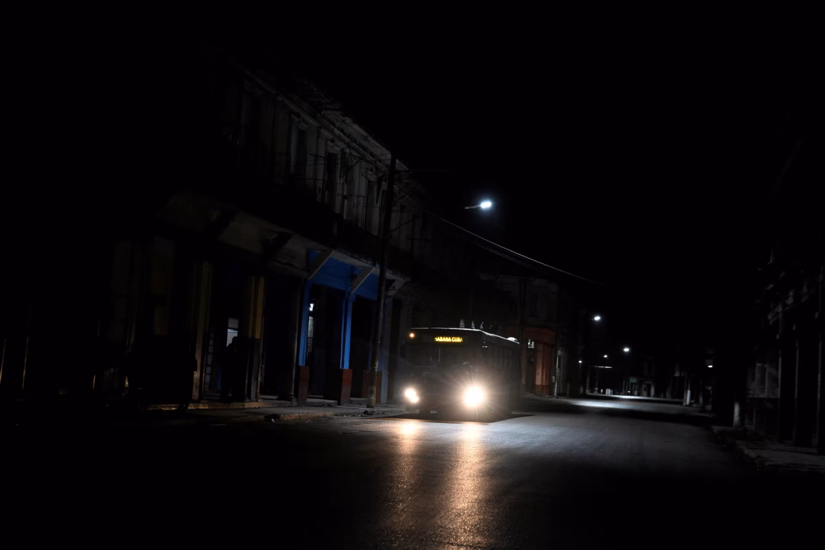 A bus driving along the dark streets of Cuba after power outage
