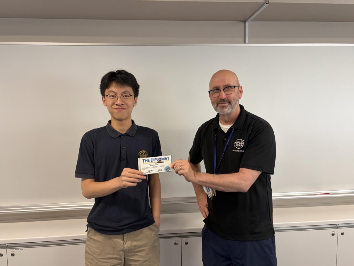 Jonathan('29) receives his certificate and lapel pin from Diplomat Publisher Mr. Douglas. May 12, 2026